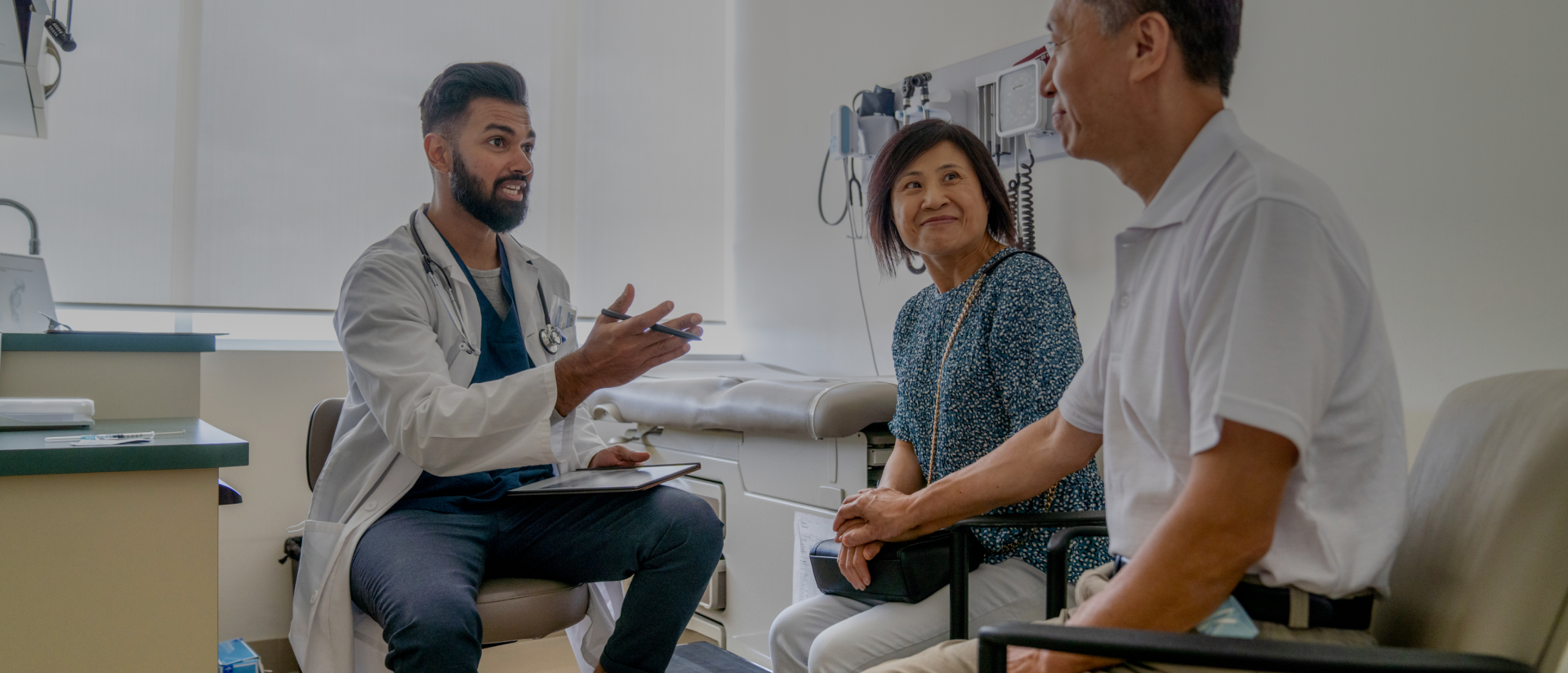 a doctor speaking to a patient and his wife