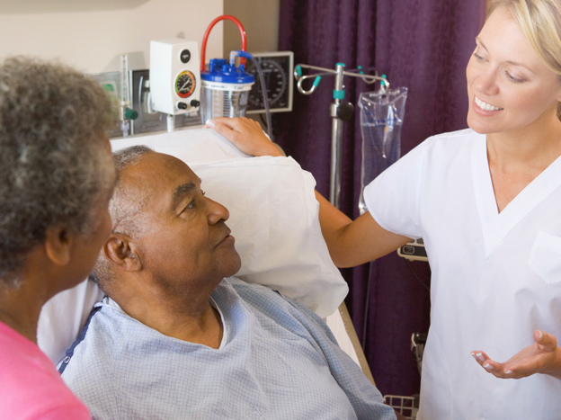 a doctor speaking to a patient and his wife