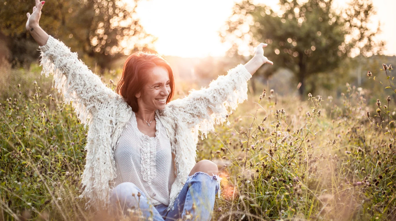 a woman sitting in a field