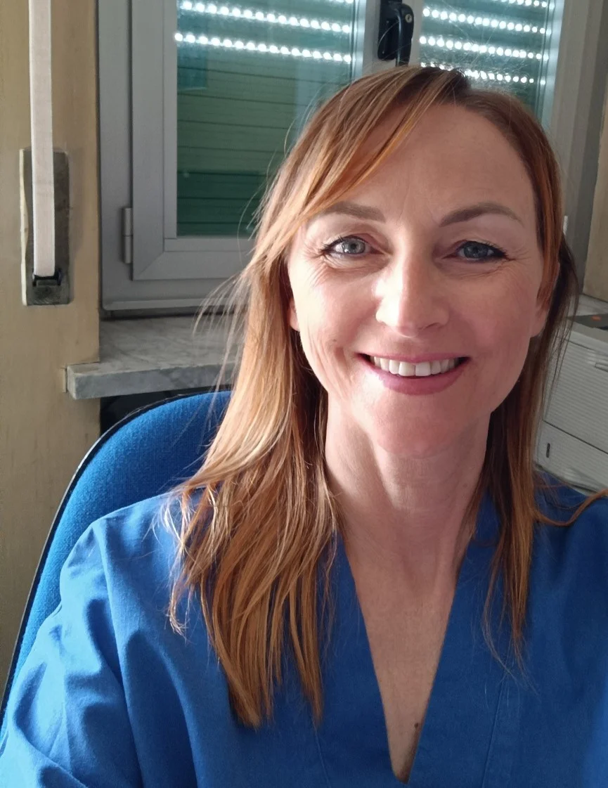 una donna che sorride per la macchina fotografica